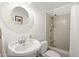 Bathroom featuring a pedestal sink, decorative mirror and a tiled shower over the bathtub at 3018 E Mulberry Dr, Phoenix, AZ 85016