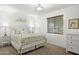 Light and airy bedroom with a metal bed frame, soft carpet, and bright window at 3018 E Mulberry Dr, Phoenix, AZ 85016
