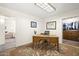 Spacious home office with an ornate desk, colorful rug, and closet with abundant storage space at 3018 E Mulberry Dr, Phoenix, AZ 85016