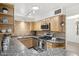Well-appointed kitchen featuring granite countertops, stainless steel appliances, and stylish wood cabinetry at 3018 E Mulberry Dr, Phoenix, AZ 85016