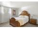 Comfortable main bedroom with a wooden bed frame, soft lighting, and a serene atmosphere at 3018 E Mulberry Dr, Phoenix, AZ 85016