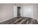 Neutral bedroom featuring wood-look floors, providing a blank canvas for personalization and comfort at 30938 W Mitchell Dr, Buckeye, AZ 85396