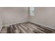 Cozy bedroom with gray walls, wood-look floors, and a window offering natural light and a modern feel at 30938 W Mitchell Dr, Buckeye, AZ 85396