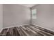 Well-lit bedroom with neutral walls and modern gray wood-look flooring, offering a serene and stylish space at 30938 W Mitchell Dr, Buckeye, AZ 85396
