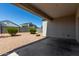 Covered patio area with gravel landscaping and views of neighboring homes for outdoor enjoyment at 30938 W Mitchell Dr, Buckeye, AZ 85396