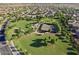 Aerial view of a well-maintained community park with tennis courts and green spaces at 3131 S Mingus Dr, Chandler, AZ 85286