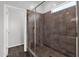 Bathroom featuring a modern glass-enclosed shower with brown tile and updated fixtures at 3131 S Mingus Dr, Chandler, AZ 85286