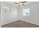Cozy bedroom with neutral carpet, two windows offering ample natural light, and a ceiling fan at 3131 S Mingus Dr, Chandler, AZ 85286