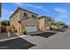 Charming two-story townhome with a two-car garage, desert landscaping, and a well-maintained exterior at 3131 S Mingus Dr, Chandler, AZ 85286
