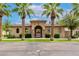 Charming community clubhouse featuring a tile roof, stone accents, and arched entryway, creating an inviting and luxurious ambiance at 3131 S Mingus Dr, Chandler, AZ 85286