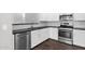 Stylish kitchen with white cabinets, stainless steel appliances, subway tile backsplash, and dark wood-look floors at 3131 S Mingus Dr, Chandler, AZ 85286