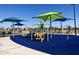 Colorful playground with various play structures, shaded areas, and soft, blue safety surfacing at 3131 S Mingus Dr, Chandler, AZ 85286