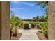 Scenic view of a pond surrounded by lush greenery and desert landscaping at 3131 S Mingus Dr, Chandler, AZ 85286