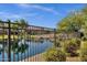 View of the pond and fountain with desert landscaping and surrounding homes at 3131 S Mingus Dr, Chandler, AZ 85286