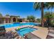 Resort-style community pool and spa surrounded by palm trees and comfortable lounge chairs, perfect for relaxation at 3131 S Mingus Dr, Chandler, AZ 85286