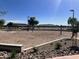 Sand volleyball court with nets, landscaping, and a seating area, ideal for outdoor recreation at 3131 S Mingus Dr, Chandler, AZ 85286