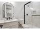 Chic bathroom featuring a white vanity, modern lighting, and a glass shower at 31652 N Misty Ln, Queen Creek, AZ 85142