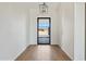 Bright entryway with light walls, wood-style floors, and a black framed glass front door at 31652 N Misty Ln, Queen Creek, AZ 85142
