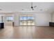 Open-concept living room featuring wood-look floors, white walls, recessed lighting, and a sliding glass door at 31652 N Misty Ln, Queen Creek, AZ 85142