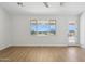 Bright living room with natural light, featuring hardwood floors and beautiful mountain views from large windows at 31652 N Misty Ln, Queen Creek, AZ 85142