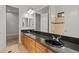 Well-appointed bathroom with double sinks, granite countertops, tiled shower providing a luxurious spa-like experience at 3215 E Constance Way, Phoenix, AZ 85042