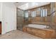 Luxurious bathroom featuring a tiled shower, soaking tub, and elegant fixtures for ultimate relaxation at 3215 E Constance Way, Phoenix, AZ 85042