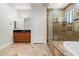 Well-lit bathroom features a glass-enclosed shower, tub, and stylish vanity with granite counters and mirrors at 3215 E Constance Way, Phoenix, AZ 85042