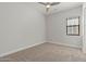 Inviting bedroom with carpet, ceiling fan, and ample natural light for a comfortable living space at 3215 E Constance Way, Phoenix, AZ 85042