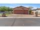 Charming home featuring a three car garage, brick driveway and beautifully landscaped yard with stone accents at 3215 E Constance Way, Phoenix, AZ 85042