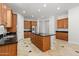 Large kitchen with dark countertops, stainless appliances, wooden cabinets, and tile floors at 3215 E Constance Way, Phoenix, AZ 85042