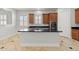 Open kitchen featuring a center island with dark granite countertops, wood cabinets, and tile flooring at 3215 E Constance Way, Phoenix, AZ 85042