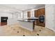 Open-concept kitchen featuring dark countertops, wood cabinetry, an island, and stainless appliances at 3215 E Constance Way, Phoenix, AZ 85042
