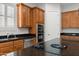 Gourmet kitchen features dark countertops, a cooking island, and stainless steel appliances at 3215 E Constance Way, Phoenix, AZ 85042