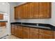 Traditional style kitchen featuring dark granite countertops, wood cabinets, and tile flooring at 3215 E Constance Way, Phoenix, AZ 85042