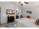 Relaxing bedroom featuring wood laminate floors and a mounted television at 3911 W Quail Ave, Glendale, AZ 85308