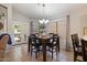 Bright dining area with backyard access and modern chandelier lighting at 3911 W Quail Ave, Glendale, AZ 85308