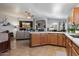 Open kitchen with warm wood cabinets, quartz countertops and stainless appliances at 3911 W Quail Ave, Glendale, AZ 85308