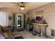 Covered patio with comfortable seating, an outdoor ceiling fan, and an American flag wall decoration at 3911 W Quail Ave, Glendale, AZ 85308