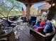 Charming balcony with comfortable seating, decorative pillows, and views of the lush landscape at 3935 E Rough Rider Rd # 1066, Phoenix, AZ 85050