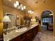 The bathroom features dual sinks, a tiled floor, and a decorative mirror at 3935 E Rough Rider Rd # 1066, Phoenix, AZ 85050