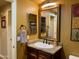 Bathroom vanity with granite counters, dual mirrors and a decorative light fixture at 3935 E Rough Rider Rd # 1066, Phoenix, AZ 85050