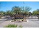 Community entrance with brick signage, mature landscaping, and secure gated access at 3935 E Rough Rider Rd # 1066, Phoenix, AZ 85050