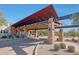 Grand entrance featuring stone pillars, desert landscaping, covered walkways and architectural details at 3935 E Rough Rider Rd # 1066, Phoenix, AZ 85050