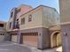 Multi-level condo exterior highlighting the attached garages and distinct architectural style at 3935 E Rough Rider Rd # 1066, Phoenix, AZ 85050