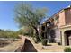 Charming condo with a private balcony, lush landscaping, and a well-maintained walkway at 3935 E Rough Rider Rd # 1066, Phoenix, AZ 85050