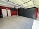 Spacious three car garage with epoxy floor, built-in cabinets, and painted walls at 3935 E Rough Rider Rd # 1066, Phoenix, AZ 85050