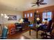 Well-lit home office featuring a ceiling fan, built-in shelving, and functional workspace at 3935 E Rough Rider Rd # 1066, Phoenix, AZ 85050