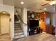 Inviting living area with stone accent wall, decorative clock, and staircase to the upper level at 3935 E Rough Rider Rd # 1066, Phoenix, AZ 85050
