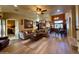 Open-concept living room featuring wood floors, tan walls, and kitchen access at 3935 E Rough Rider Rd # 1066, Phoenix, AZ 85050