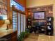 Home office with stone accent wall and built-in shelving at 3935 E Rough Rider Rd # 1066, Phoenix, AZ 85050